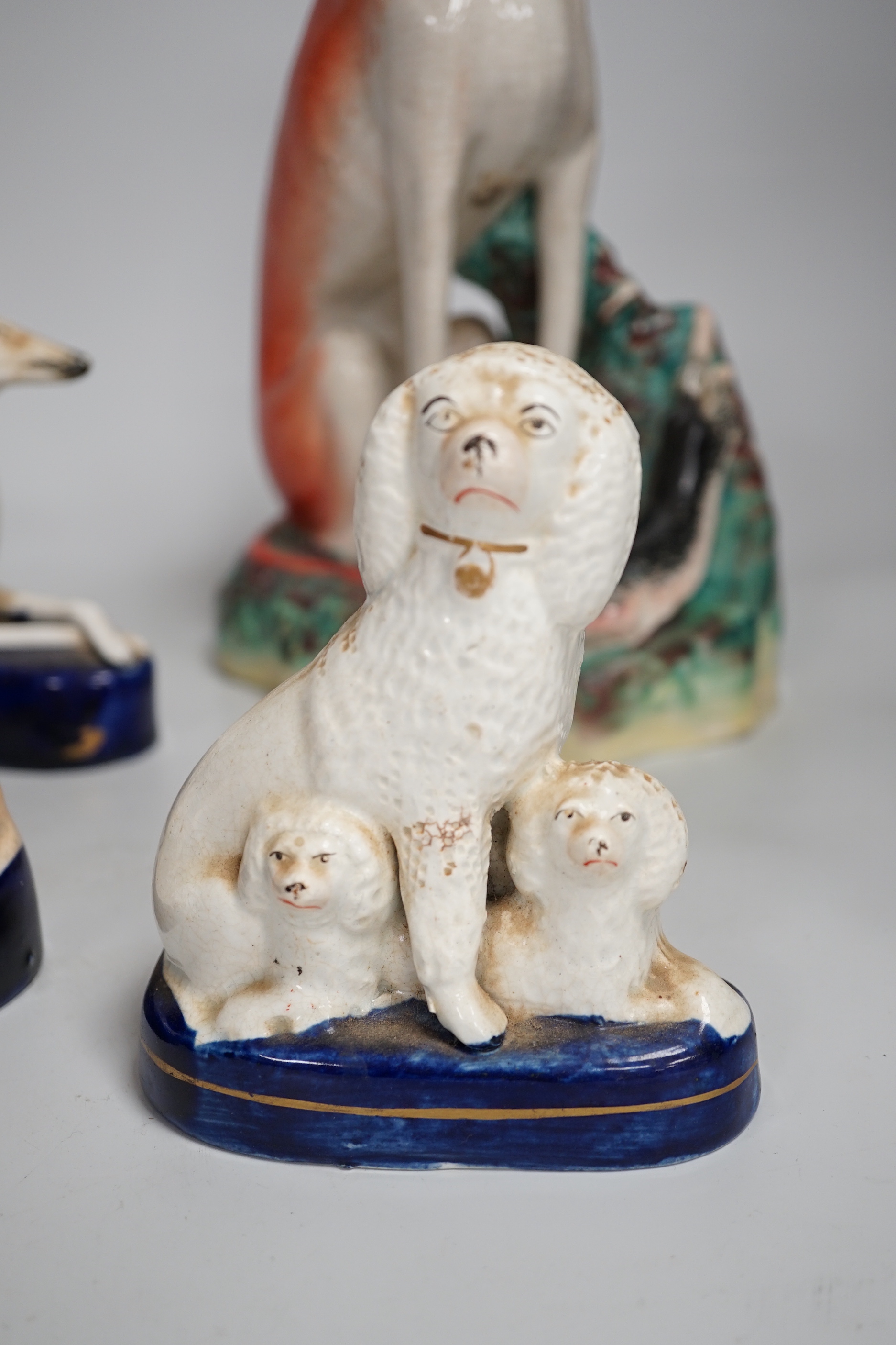 Four Staffordshire dogs including greyhounds and a spaniel, the largest 29cm high